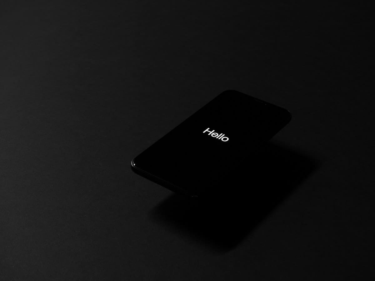 A black smartphone on a dark surface, representing the be1 crypto mobile trading app